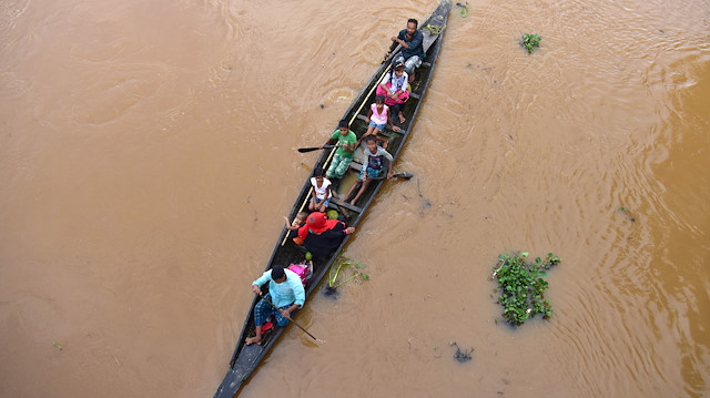 Flood-affected villagers are transported on a boat to a safer place at Kachua village in Nagaon district, in the northeastern state of Assam, India, July 22, 2020.