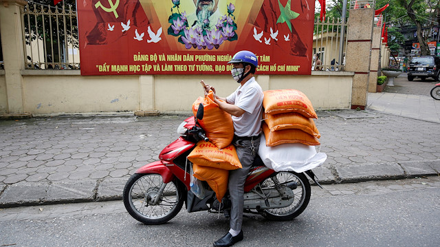 A donor carries rice bags to distribute to poor people during the coronavirus in Hanoi, Vietnam, on April 16, 2020.
