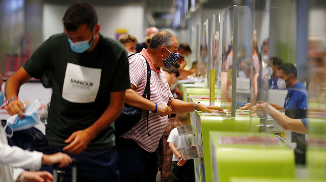 British tourists returning to UK, check in their luggage, as Britain imposed a two-week quarantine on all travellers arriving from Spain, following the coronavirus disease (COVID-19) outbreak, at Gran Canaria Airport, on the island of Gran Canaria, Spain July 25, 2020. REUTERS/Borja Suarez

