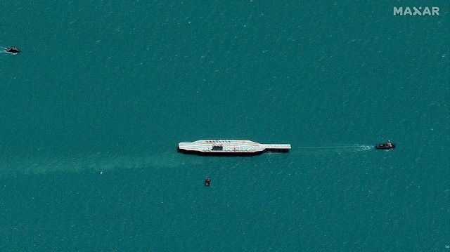 Iran's refurbished mockup aircraft carrier, used previously as a simulated U.S. target during a February, 2015 Iranian naval war games exercise, is seen towed by a tugboat near Bandar Abbas, Iran July 25, 2020. Picture taken July 25, 2020. Satellite image ©2020 Maxar Technologies/via Reuters