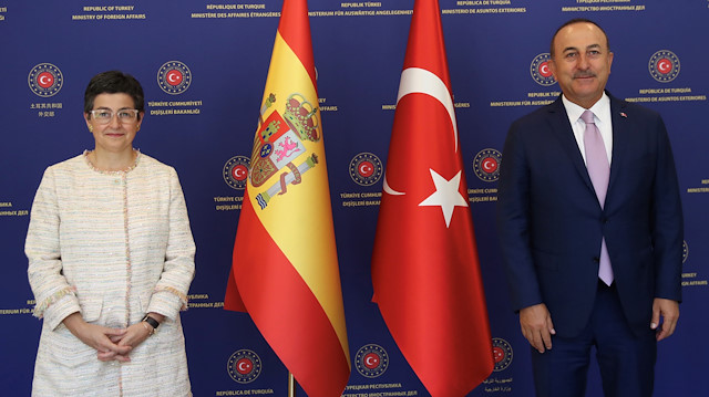 Turkish Foreign Minister Mevlut Cavusoglu and his Spanish counterpart Arancha Gonzalez Laya pose before their meeting in Ankara, Turkey, July 27, 2020