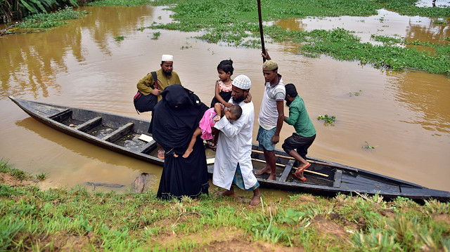 FILE PHOTO: Flood-affected villagers disembark a boat after they reached a safer place at Kachua village in Nagaon district, in the northeastern state of Assam, India, July 22, 2020