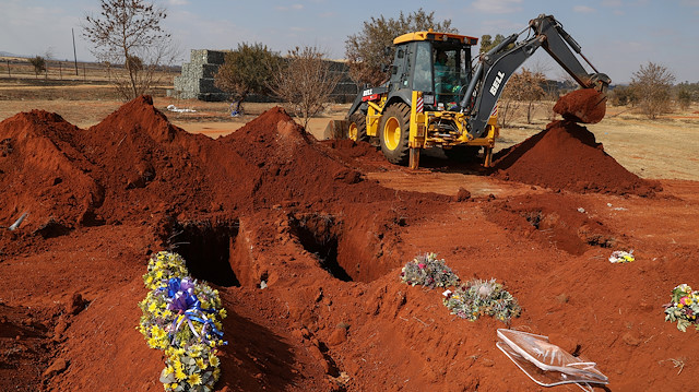 An excavator is seen digging graves amid a nationwide coronavirus disease (COVID-19) lockdown, at the Olifantsvlei cemetery, south-west of Joburg, South Africa July 28, 2020. 
