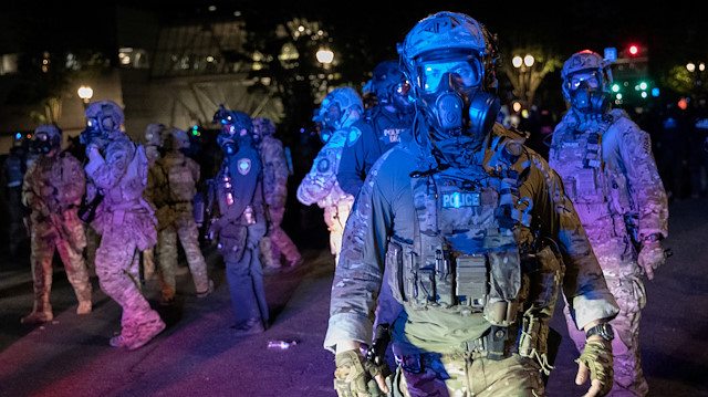 Federal law enforcement officers face off with protesters during a demonstration against police violence and racial inequality in Portland, Oregon, U.S., July 30, 2020
