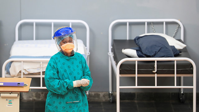 A health worker walks between beds at a temporary field hospital set up by Medecins Sans Frontieres (MSF) during the coronavirus disease (COVID-19) outbreak in Khayelitsha township near Cape Town, South Africa, July 21, 2020.
