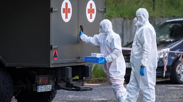 Health workers wearing protective gear are seen at a mobile testing station for miners of the Bielszowice coal mine, following the coronavirus disease (COVID-19) outbreak in Ruda Slaska, Poland July 27, 2020. Grzegorz Celejewski/Agencja Gazeta/via REUTERS