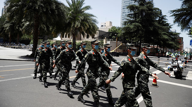 Chinese paramilitary police march outside the U.S. Consulate General in Chengdu, Sichuan province, China, July 26, 2020, after China ordered its closure in response to U.S. order for China to shut its consulate in Houston. REUTERS/Thomas Peter

