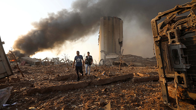 Men walk at the site of an explosion in Beirut, Lebanon August 4, 2020. REUTERS/Mohamed Azakir


