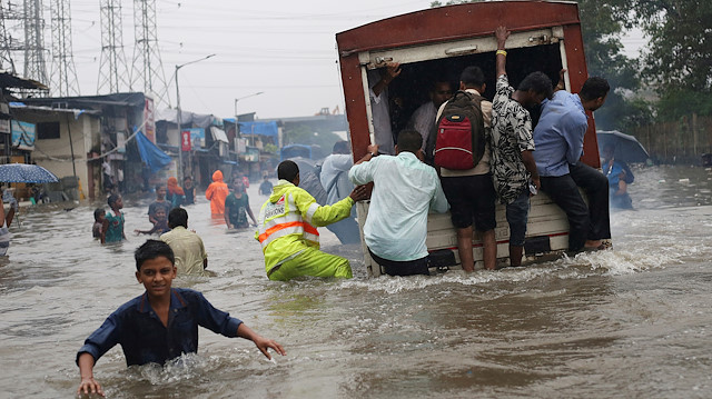 People ride on a truck on a flooded road after a heavy rainfall in Mumbai, India, September 4, 2019. REUTERS/Francis Mascarenhas