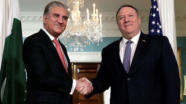 U.S. Secretary of State Mike Pompeo (R) shakes hanse with Pakistani Foreign Minister Shah Mehmood Quresh