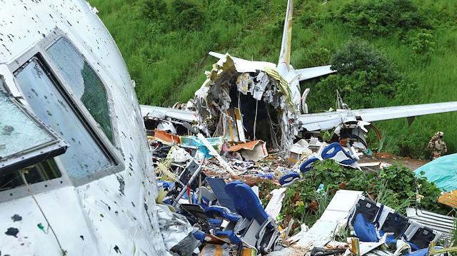 A security official inspects the site where a passenger plane crashed