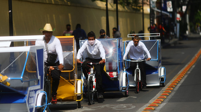 A bicycle taxi driver wearing a face mask works on a street as the coronavirus disease (COVID-19) outbreak continues, in Xochimilco, Mexico City, Mexico, August 6, 2020.