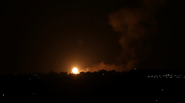 Flame and smoke are seen during an Israeli air strike in the central Gaza Strip