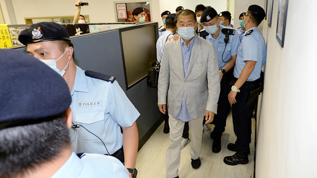 Media mogul Jimmy Lai Chee-ying, founder of Apple Daily is seen escorted by Hong Kong police at the Apple Daily office in Hong Kong, China August 10, 2020.