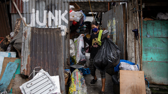 Waste picker Virgilio Estueta, 60, carries bags of trash out of his junk shop amid the coronavirus disease (COVID-19) outbreak, in Quezon City, Metro Manila, Philippines, July 7, 2020. Picture taken July 7, 2020.