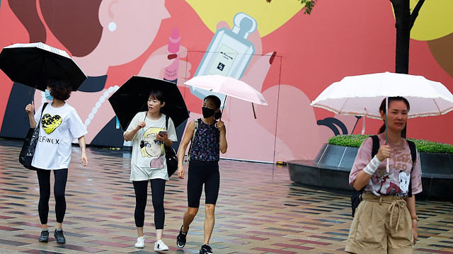 People carry umbrellas on a rainy day following an outbreak of the coronavirus disease (COVID-19) in Beijing, China August 12, 2020.