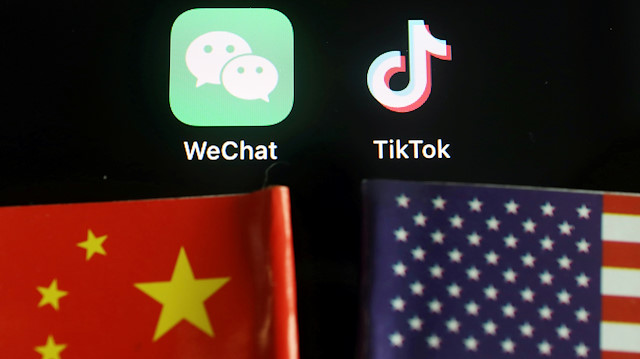 The messenger app WeChat and short-video app TikTok are seen near China and U.S. flags in this illustration picture taken August 7, 2020.