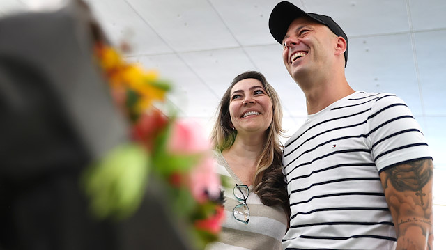 Florian Mehler and his Brazilian girlfriend Renata Alves smile during a TV interview with Reuters as the couple reunites following a six month lockdown due the outbreak of the coronavirus disease (COVID-19) at the airport in Frankfurt, Germany, August 15, 2020. 