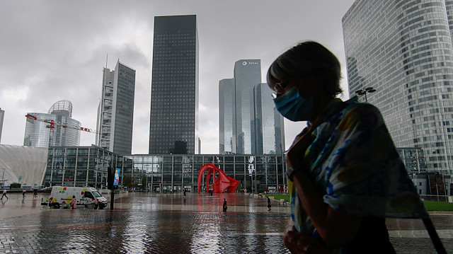 File photo: A woman wearing a protective mask walks at the financial and business district of La Defense as France reinforces mask-wearing in public places as part of efforts to curb a resurgence of the coronavirus disease (COVID-19) across the country, near Paris, France August 17, 2020