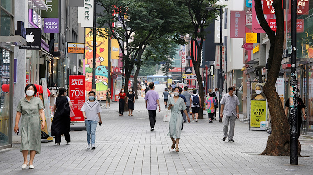 People wearing masks walk at Myeongdong shopping district, as social distancing measures were introduced to avoid the spread of the coronavirus disease (COVID-19), in Seoul, South Korea, August 19, 2020. 