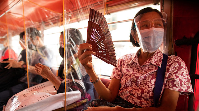 Jeepney passengers seated in between plastic barriers, wear face masks and face shields mandatory in public transportation, to help curb coronavirus disease (COVID-19) infections, in Quezon City, Metro Manila, Philippines, August 19, 2020.