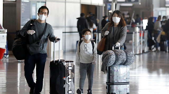 File photo: Travellers wearing protective face masks walk inside Paris Charles de Gaulle airport in Roissy-en-France near Paris during the outbreak of the coronavirus disease (COVID-19) in France May 14, 2020