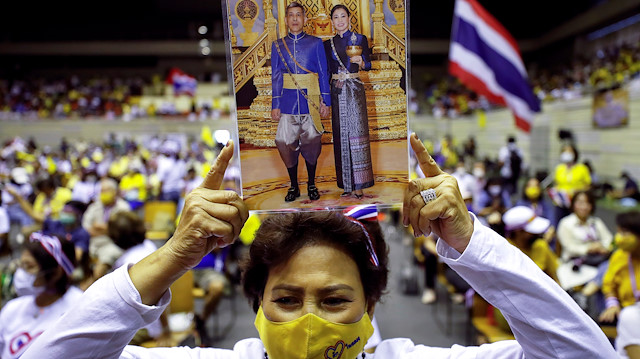 A person holds a picture of Thai King Maha Vajiralongkorn with Queen Suthida as members of Thai right-wing group "Thai Pakdee" (Loyal Thai) attend a rally in support of the government and the monarchy and in opposition to the recent anti-government protests, in Bangkok, Thailand August 30, 2020.
