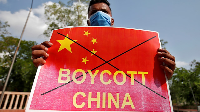 FILE PHOTO: A member of National Students' Union of India (NSUI) holds a placard during a protest against China, in Ahmedabad, India, June 18, 2020. REUTERS/Amit Dave/File Photo

