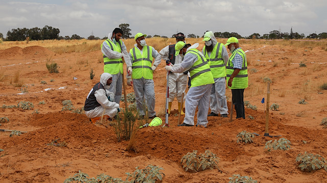 Members of the Government of National Accord's (GNA's) missing persons bureau search for human remains in what Libya's internationally recognized government officials say is a mass grave, in Tarhouna city, Libya June 23, 2020. Picture taken June 23, 2020. REUTERS/Ismail Zitouny

