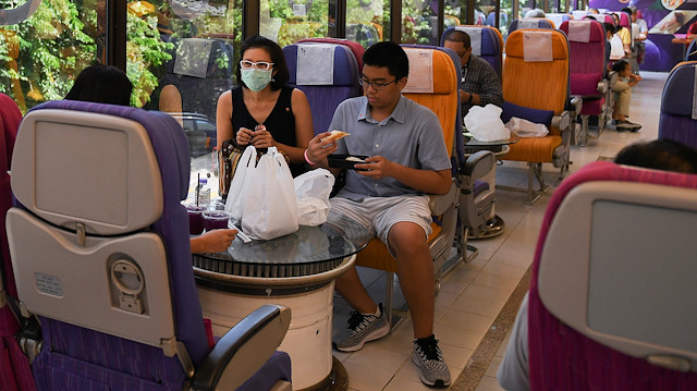 Customers eat at Thai Airways pop-up airplane-themed restaurant at the airlines headquarters with onboard meals prepared by their chefs, while their fleet is still grounded at the airport and the company awaits a bankruptcy court decision, in Bangkok, Thailand September 3, 2020. REUTERS/Chalinee Thirasupa