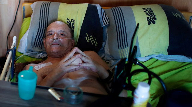 Alain Cocq, 57, in his medical bed he has been confined to for years as a result of a degenerative disease that has no treatment, poses after an interview with Reuters at his home in Dijon, France, August 19, 2020. Picture taken on August 19, 2020.