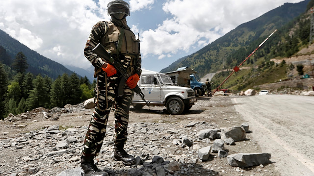 An Indian Central Reserve Police Force (CRPF) personnel stands guard at a checkpoint along a highway leading to Ladakh, at Gagangeer in Kashmir's Ganderbal district September 2, 2020. REUTERS/Danish Ismail

