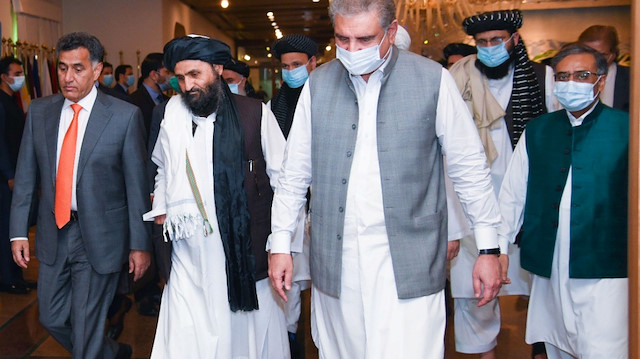 Pakistan's Foreign Minister Shah Mahmood Qureshi walks with Mullah Abdul Ghani Baradar (2nd L), the leader of the Taliban delegation, upon his arrival at the Ministry of Foreign Affairs (MOFA) office in Islamabad, Pakistan August 25, 2020. Ministry of Foreign Affairs (MoFA)/Handout via REUTERS