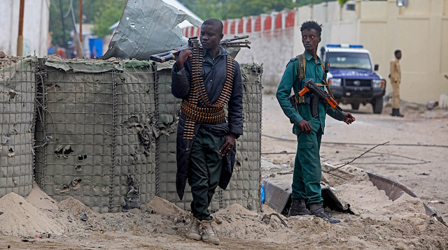 Somali policemen stand at the scene after suicide car bomber drove into a checkpoint outside the port in Mogadishu, Somalia July 4, 2020 REUTERS/Feisal Omar

