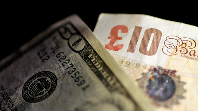 FILE PHOTO: British Pound Sterling and U.S. Dollar notes are seen in this June 22, 2017 illustration photo. REUTERS/Thomas White/Illustration/File Photo