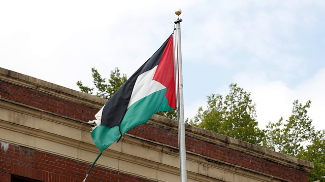 A tattered flag flies over the Palestine Liberation Organization (PLO) office