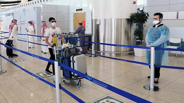 A traveller wearing a protective face mask wheels his bags at Riyadh International Airport, after Saudi Arabia reopened domestic flights, following the outbreak of the coronavirus disease (COVID-19), in Riyadh, Saudi Arabia May 31, 2020