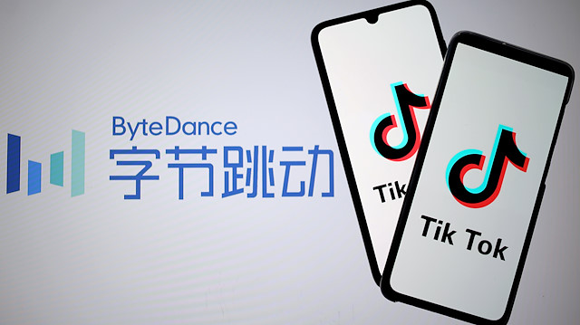 TikTok logos are seen on smartphones in front of a displayed ByteDance logo