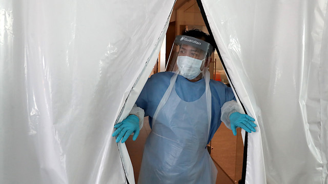 FILE PHOTO: A technician enters the new COVID-19 testing lab at Queen Elizabeth University Hospital, amid the coronavirus disease epidemic in Glasgow, Britain April 22, 2020. 
