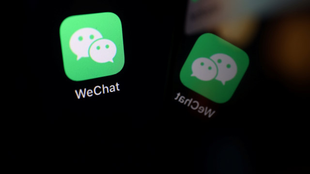 The sign of the WeChat app is seen reflected on a mobile phone in this illustration picture 
