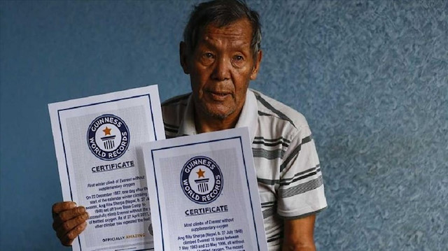 Ang Rita Sherpa holds his Guinness World Records certificates in Kathmandu in June 2017. (Anadolu Agency)