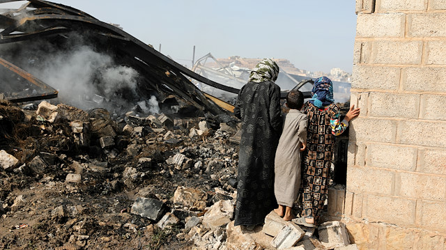 File photo: Children look at wreckage of a vehicle oil and tires store hit by Saudi-led air strikes in Sanaa, Yemen July 2, 2020. REUTERS/Khaled Abdullah  