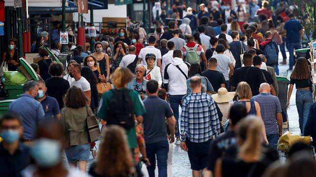 People wearing protective face masks walk in a busy street in Paris as France reinforces mask-wearing in public places as part of efforts to curb a resurgence of the coronavirus disease (COVID-19) across France, September 18, 2020. REUTERS/Gonzalo Fuentes

