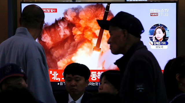 FILE PHOTO: People watch a TV broadcast showing a file footage for a news report on North Korea firing two projectiles, possibly missiles, into the sea between the Korean peninsula and Japan, in Seoul, South Korea, October 31, 2019. 