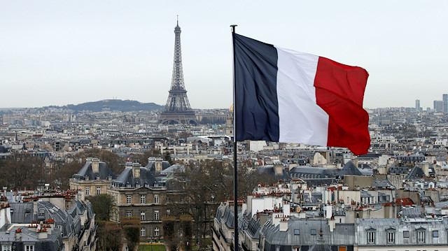 FILE PHOTO: A city view shows the French flag above the skyline of the French capital as the Eiffel Tower and roof tops are seen in Paris, France, March 30, 2016. 