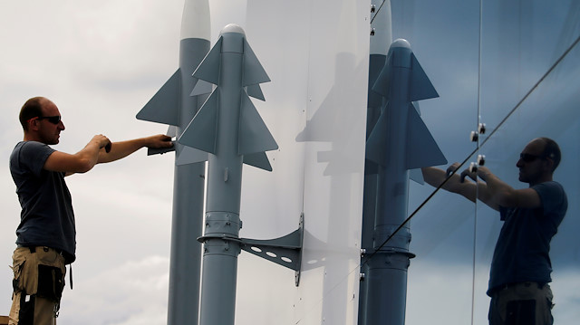 FILE PHOTO: A worker installs two Rafael Air Missile Defence models, before the opening of the 53rd Paris Air Show at Le Bourget Airport near Paris, France June 14 2019. REUTERS/Pascal Rossignol/File Photo