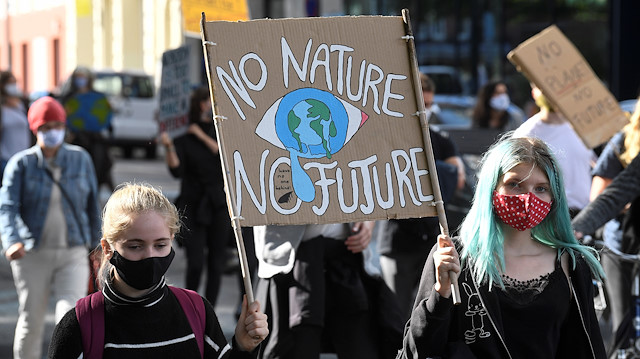 Demonstrators hold a sign as Fridays for Future activists protest calling for a "Global Day of Climate Action" in Hamburg, Germany, September 25, 2020. 