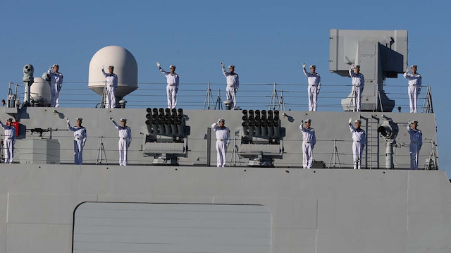 Chinese Navy members wave 
