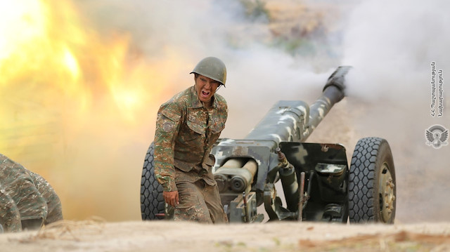 An ethnic Armenian soldier fires an artillery piece during fighting with Azerbaijan's forces in the breakaway region of Nagorno-Karabakh, in this handout picture released September 29, 2020. Defence Ministry of Armenia/Handout via REUTERS