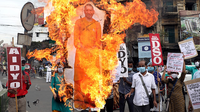 Activists of Socialist Unity Centre of India (SUCI) shout slogans and burn a cut-out of Yogi Adityanath, Chief Minister of the northern state of Uttar Pradesh, during a protest after the death of a rape victim, who was brought from a hospital in Uttar Pradesh to New Delhi's Safdarjung Hospital, where she died while undergoing treatment on Tuesday, in Kolkata, India, September 30, 2020.